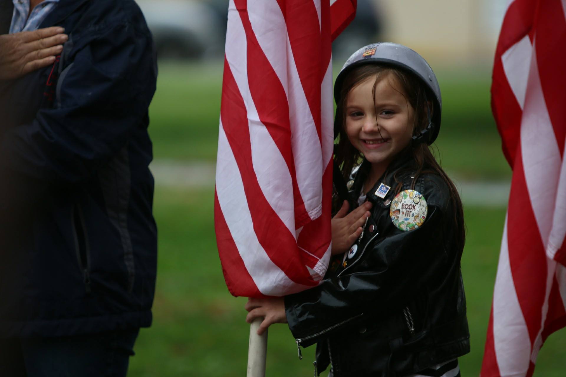 girl saying pledge with flag's image